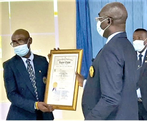 Lion Godfrey Lord Crentsil (left) receiving the charter from District Governor, Lion David Anokye, PMJF