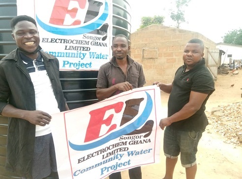 Flashback: Joshua Anim ,treasurer Ada Youth For Devlopment, (AYFD), left, holds the association's banner with James Tsiani Gadugah (centre) and a member of the asociation