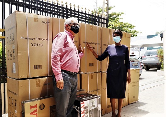 Mr Ramesh Sadhwani (left), Joint Managing Director of the Melcom Group, making a presentation to Ms Hellen Tettey, the Administrator of the Mamobi General Hospital