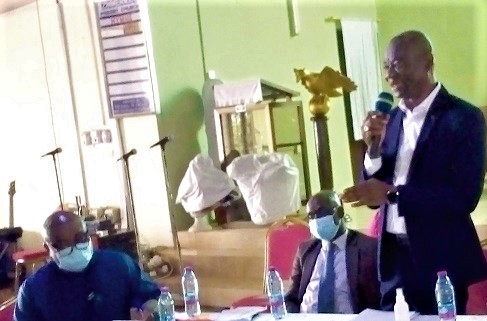 Mr Anokye Abebrese (standing), Director, Customer Services of ECG, explaining a point at the engagement