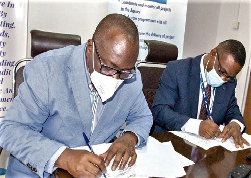 Professor Kwasi Prempeh (left), Executive Director of CDD-Ghana, and  Dr Eric Oduro Osae, Director-General of the IAA, signing  the agreement documents