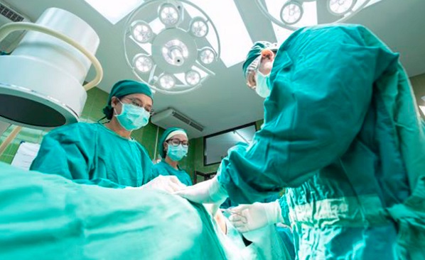 Surgeons performing a procedure on a hernia patient
