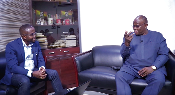 Dr Ekwow Spio-Garbrah (right) explaining some of the issues around the E-Levy to Charles Benoni Okine 