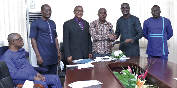 Prof. Frederick Sarfo (4th from left), VC of AAMUSTED, exchanging document with Mr Kofi Akowuah Kyei (2nd from right), CEO of MOFCO