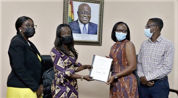 Mrs Delese Mimi A. A. Darko (2nd from left), CEO of FDA, exchanging the document with Mrs Sally Ofori Yeboah (2nd from right), National Director, CAMFED. With them are Ms Yvonne Nkrumah (left), Deputy CEO, in charge of Corporate Service Division and Mr Emmanuel Adjei, Head of Programmes, CAMFED Ghana