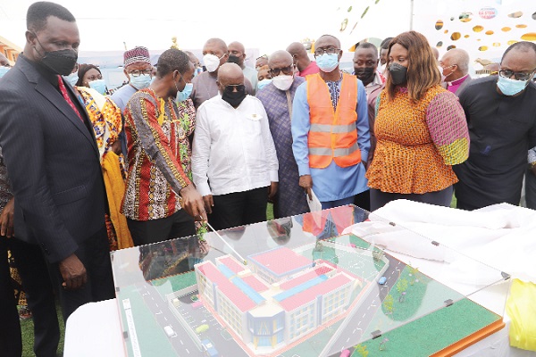 President Akufo-Addo being briefed by Mr Samuel Antwi (2nd from left), the architect on the project. With them is Dr Yaw Adutwum (left), the Minister of Education. Picture: SAMUEL TEI ADANO