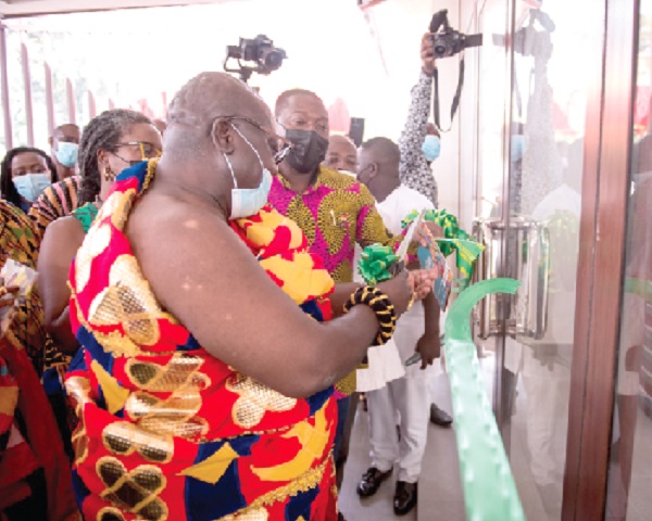 Otoobour Djan Kwasi II (left), the Aburihene, assisted by other dignitaries to cut the tape for the opening of the newly refurbished Aburi Crafts Village