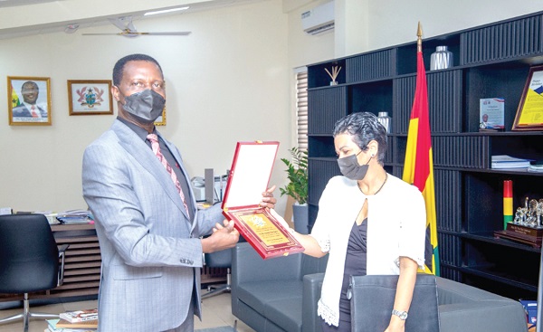 Dr Yaw Osei Adutwum, Education Minister, making a presentation to Mrs Anette Chao Garcia, the Cuban Ambassador to Ghana