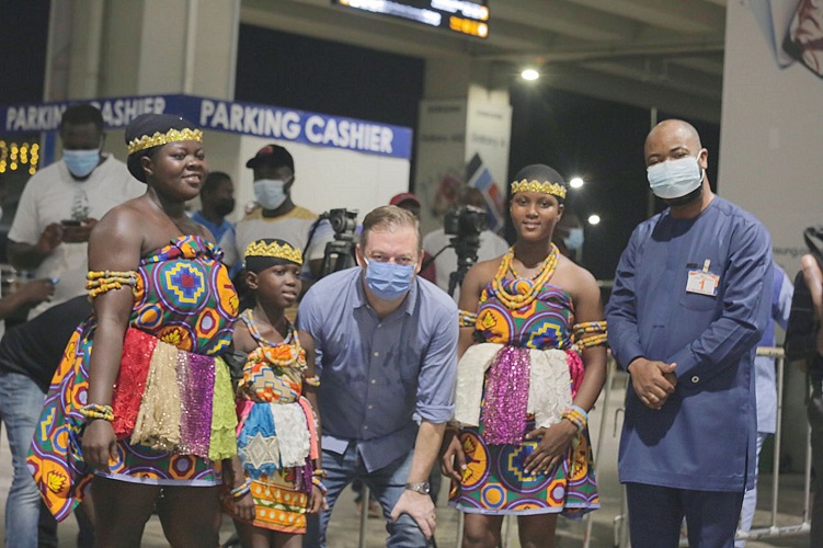 Mr Andrew Persoms (middle) being welcomed by traditional dancers and Mr Samson Deen (right), president of the African Paralympic Committee