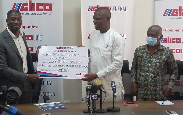 Mr Achampong-kyei (left), managing Director of GLICO General, presenting the dummy cheque of GHC 2.05 million to Mr Mustapha Ussif, the Minister for youth and sports