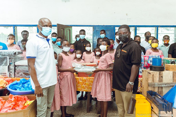 Director of X-Treme Engineering company, Mr. Kodwo Obo Kumi-Korsah (right) presenting the items to the headmaster of the school Yemoson