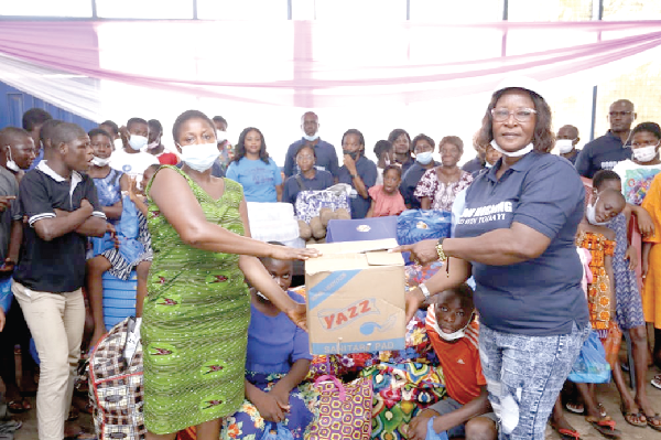 Mrs Millicent Ofori Atta (right), handing over the items to Ms Naomi Ansah (left), Caretaker, Echoing Hills Orphange