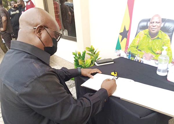 Dr Archibald Yao Letsa, Volta Regional Minister, signing the Book of Condolence in memory of Ishmael Ashitey. Picture:  BENJAMIN XORNAM GLOVER