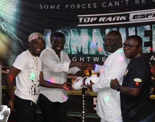 Mr Amoo-Bediako  (2nd right) presenting the equipment to Mr Charles Quartey with the help of Richard Commey (left)