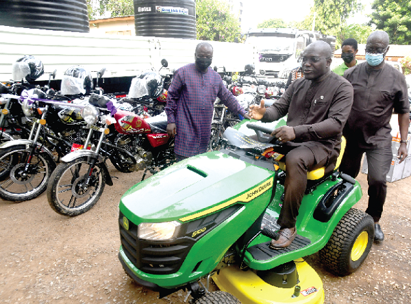 Mr Martin Adjei-Mensah Korsah, Deputy Minister of Local Government, Decentralisation and Rural Development,  testing one of the drive mowers,  while Rev. Charles Ayitey Okine, acting Director of the Department of Parks and Gardens, looks on. Picture: EMMANUEL QUAYE