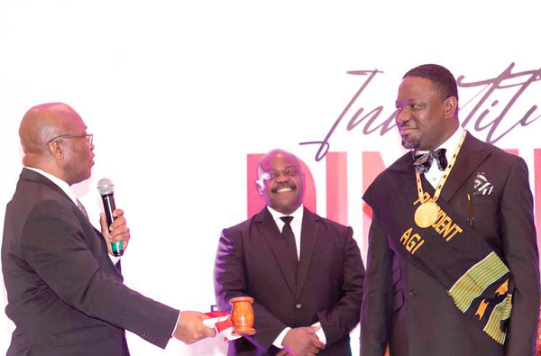 Dr Yaw Adu Gyamfi (left), the immediate past President, AGI, presenting the gavel of leadership to Dr Humphrey Kwesi Ayim Darke (right).