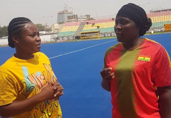 Hajia Ramatu Abass(right),Deputy Coach of the national female hockey team, interacting with defender Mavis Boatenaa Berko after a training sessions
