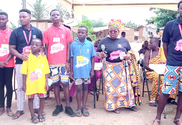 Madam Georgina Tweneboah Asa (2nd from right), mother of the Founder of the NGO, making a brief statement at the launch. With her are some children and their caretakers