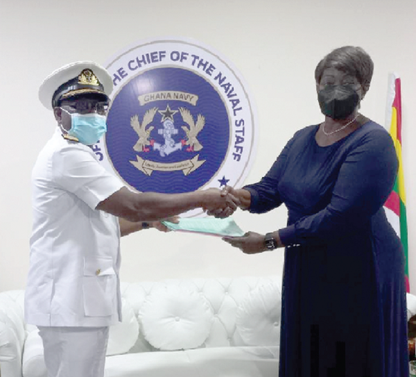 Mrs Cynthia Lumor (right), Deputy MD, Tullow Ghana, exchanging a copy of the agreement with Admiral Issah Yakubu, Chief of Naval Staff.