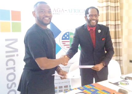 Mr Mark Ihimoyan (right), the Regional Director of Microsoft Corporation and Mr Markus Green, a board member of the AGA-Africa, exchanging the partnership agreement after the signing ceremony.