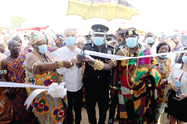  COP Tetteh Yohunu (2nd from right), Commissioner of Police in charge of Administration, with Nene Teidjahene Korabo IV (right), Senior Asafoatse, Shai Traditional Council, and Mr Ding Qing (2nd from left), Chief Executive Officer, U-Fresh Company Limited, cutting the tape to inaugurate the facility. Inset: The front view of the police station and the pick-up presented by U-Fresh Company Limited. Pictures: Samuel Tei Adano