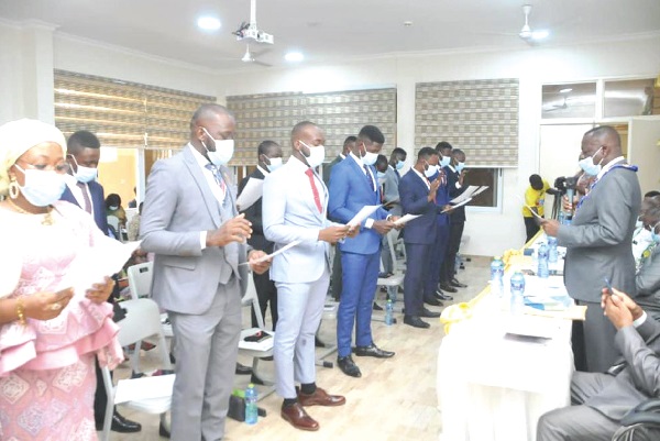 Dr Jonathan Amakye-Anim (standing right), Chairman, Veterinary Council of Ghana, swearing in 14 new veterinary doctors at the KNUST in Kumasi