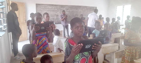 Some pupils in the school displaying their tablets in their classroom