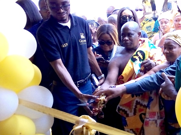 Mr Alexander Dordor (left), Director of Goldkey Limited, being assisted by other dignitaries to cut the tape to inaugurate the building