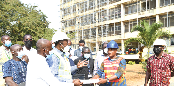 Dr Opoku Ware Ampomah (3rd from left), CEO of KBTH, being assisted by Dr Patrick Bankah (2nd from left), MD of Neurosurgeon, KBTH to hand over the contract document to Mr Francis Sorkpah (right), MD of Katalon Ghana Limited.