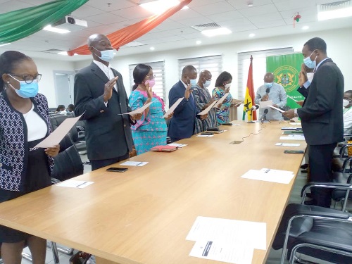 Mr Kwaku Agyeman-Manu (head of table), Minister of Health, swearing in the members of the new board of the Pharmacy Council