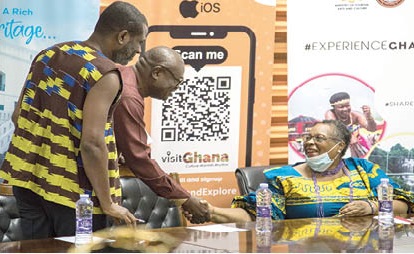 Prof. Esi Sutherland-Addy (seated)  interacting with Ekow Sampson, Deputy CEO, Operations of GTA. Looking on is Mark Okraku-Mantey (left), Deputy Minister of Tourism, Arts and Culture, at the launch of the Emancipation Day celebration