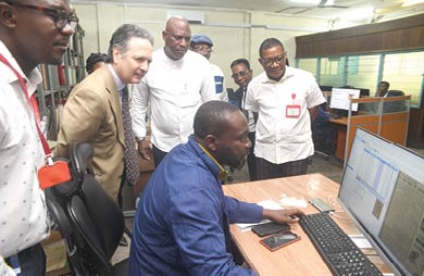 A worker at the Archives Unit of the GCGL demonstrating to Javier Gutiérrez (2nd from left), the Spanish Ambassador to Ghana. Looking on are Ato Afful (3rd from left), MD of GCGL; Kobby Asmah, Editor, Graphic, and William Ashaley, Head of the Archives Unit