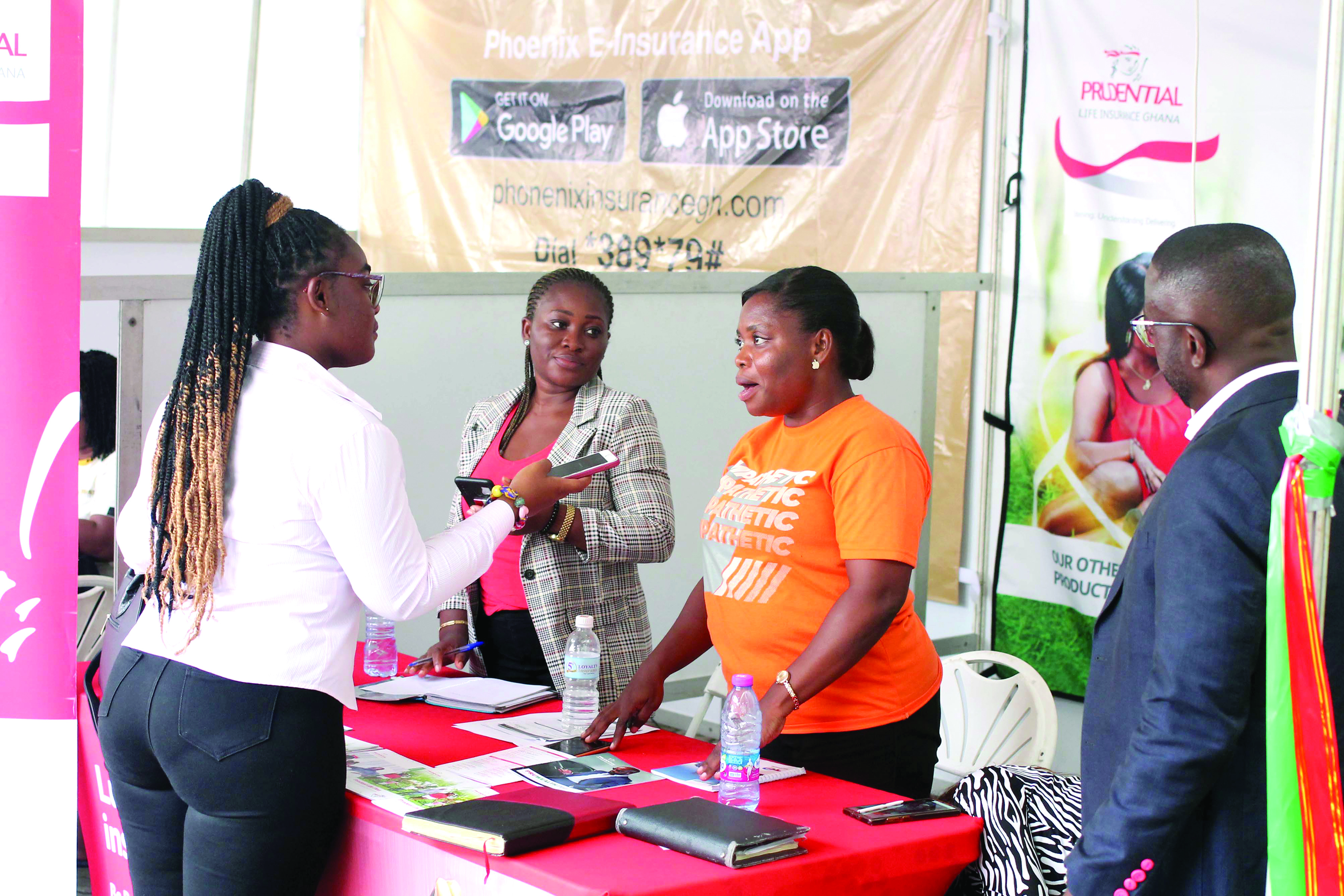   Elizabeth Nyaadu Adu (left), a reporter, and Charles Benoni Okine (right), acting Editor, Graphic Business, engaging some exhibitors on the last day of the fair 