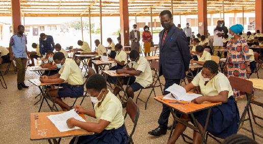    Dr. Yaw Osei Adutwum and some officials inspecting the ongoing WASSCE at the Kwabenya SHS