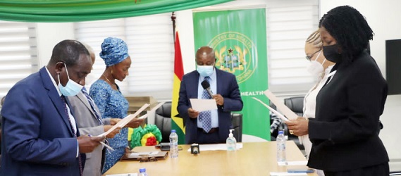 Kwaku Agyeman-Manu (middle), the Minister of Health, administering the oath of office to the reconstituted board of the Mental Health Authority