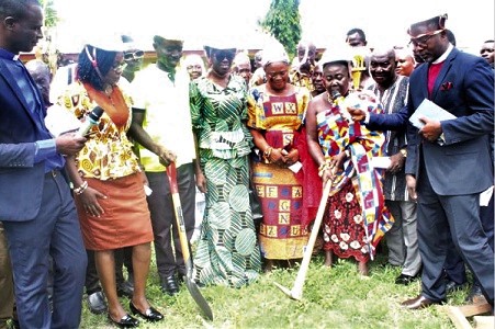  Nana Agyeiwaa Kodee II, the Queen Mother of Akyem Akokoaso, cutting  the sod for the construction of the new classroom complex as other stakeholders look on