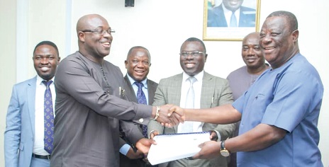 Kwasi Amoako-Atta (right), Minister of Roads and Highways, exchanging the contract document with Oliver Acquah, Chief Executive Officer, First Sky Limited
