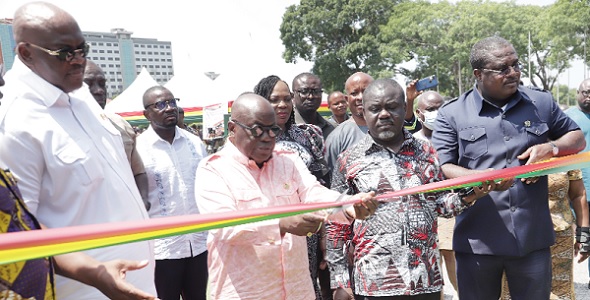  President Akufo-Addo (2nd from left), cutting a tape to commission the buses (right) in Accra. With him are Henry Quartey (left), Greater Accra Regional Minister,; Kwaku Asiamah (2nd from right), Minister of Transport, and Albert Adu Boahen (right), Managing Director, MMT. Pictures: Samuel Tei Adano