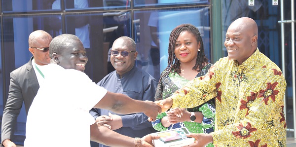 Daniel Botwe (right), Minister of Local Government, presenting a tablet to Sulemana Amidu (left), Regional Registrar, Greater Accra Region. Looking on is Henrietta Lamptey (2nd from right),  Ag Registrar Birth and Deaths and Osei-Bonsu Amoah (3rd from right), Deputy Minister for Local Government. Picture: ELVIS NII NOI DOWUONA