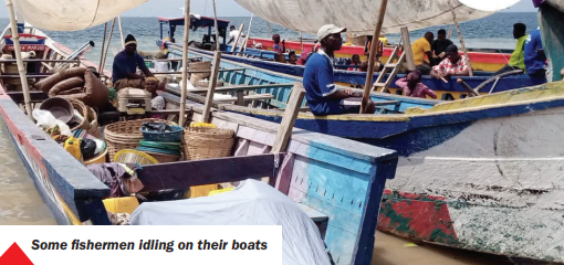 Some fishermen idling on their boats
