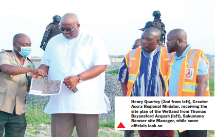 Henry Quartey (2nd from left), Greater Accra Regional Minister, receiving the site plan of the Wetland from Thomas Bayansford Acquah (left), Sakumono Ramser site Manager, while some officials look on