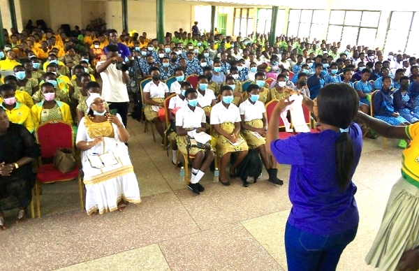 Nana Ama, a leader of the sponsors, educating the girls on how to use sanitary pads during their menstruation.