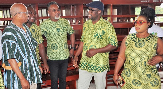 Elias Dey (2nd from right), president of the 1994 Year Group, and Jonathan Gustav Adomah (left), Headmaster of the school, in a hearty chat after the presentation
