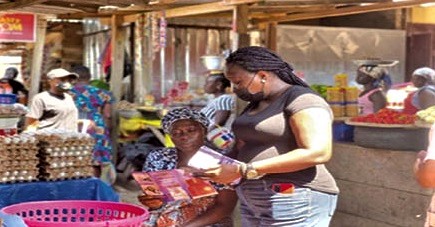 Eunice Budu Nyarko, Head, Customer Services, NPA, sharing flyers on LPG safety tips at the Abura Market in Cape Coast
