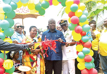 Samuel Abu Jinapor, Minister of Lands and Natural Resources, cutting the tape to commission the speedboats. With him is Nana Nkanomako IV, representative of the Chief of Nyirkyir