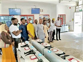 Alhaji Umar Baba Bodinga (middle), the Municipal Chief Executive for Abuakwa North, with the assembly members and some staff of the assembly at Omenako last Friday