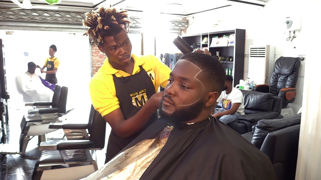 Gideon, a barber working on a model