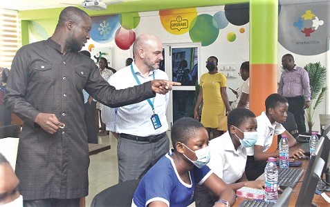  Hayford Siaw (left), Executive Director, Ghana Library Authority, conducting Fiachra McAsey (right), Deputy Representative of UNICEF, around the Youth Engagement Centre in Accra