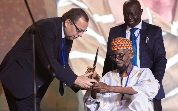 95 year old Joe Lartey, first president of the Sports Writers Association of Ghana (SWAG), receives global award in the presence of Kwabena Yeboah, at the 2022 AIPS Media Awards in Doha, Qatar.