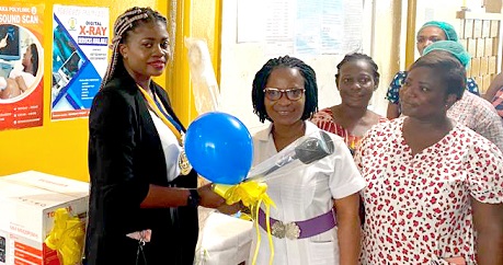  Nana Aba Asobu Sagoe (left), President of the Rotary Club of Accra-Sunrise, handing over the medical examination lamp to Vivian Gbekle (middle), Head of Nursing and Midwifery at the Adabraka Polyclinic